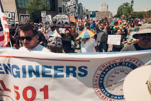 Signs in support of SB 54 at the 2017 May Day rally in Los Angeles (Creative Commons)