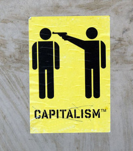 stick figures of one person with a gun to another's head, labeled capitalism