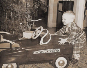 An excited young boy receives a large toy truck for Christmas
