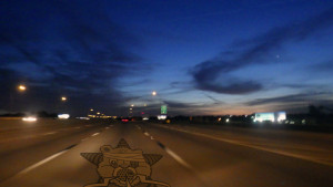 A highway late at night stretching out to eternity - with the Self Help Radio logo on the pavement in front.