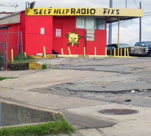 An old fix-it shop with the Self Help Radio logo on it.