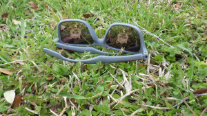 A pair of sunglasses with the Self Help Logo reflected in the lenses.