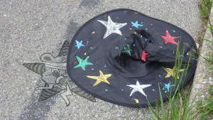 A wizard's hat abandoned by the side of the road - where someone has stamped the Self Help Radio logo.