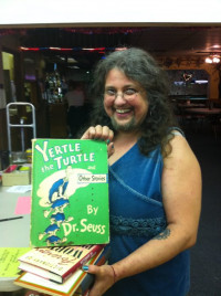 KBOO Book and Record Sale, Yertle the Turtle, Woman holding book